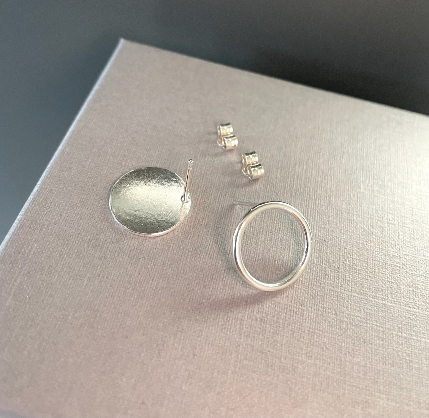 Mismatched circle stud earrings in sterling silver